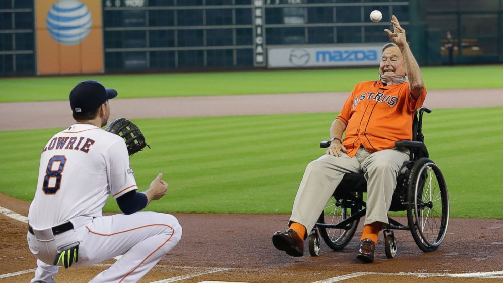 PHOTO: Former President George H.W. Bush throws out the ceremonial first pitch to Houston Astros' Jed Lowrie (8) before Game 3 of baseball's American League Division Series between the Kansas City Royals and Houston Astros, Oct. 11, 2015, in Houston. 