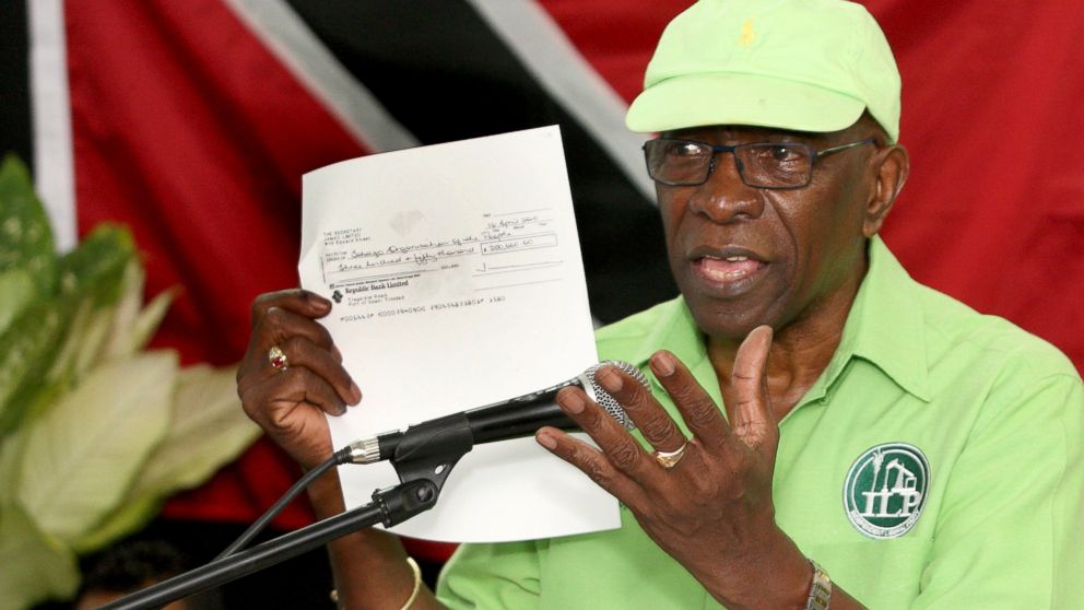Former FIFA vice president Jack Warner hold a copy of a check while he speaks at a political rally in Marabella, Trinidad and Tobago, June 3, 2015. 