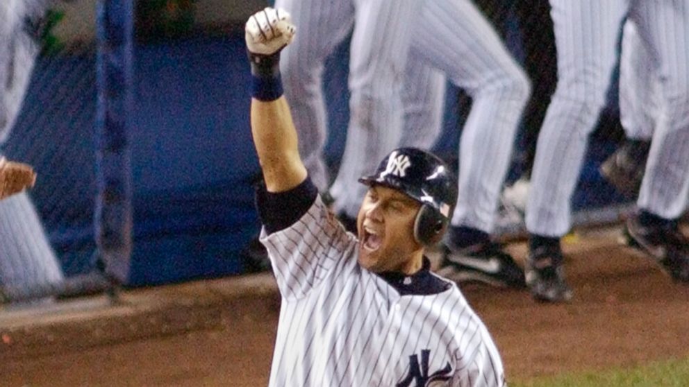 New York Yankees' Derek Jeter celebrates his game-winning home run in the 10th inning as he rounds first base against the Arizona Diamondbacks in Game 4 of the World Series in this Oct. 31, 2001 file photo at Yankee Stadium in New York.