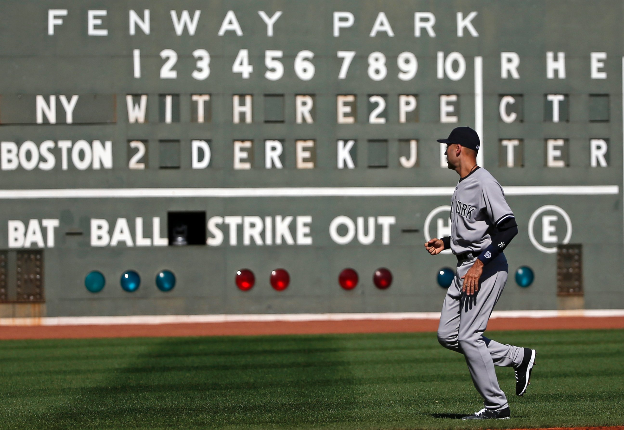PHOTO: New York Yankees' Derek Jeter jogs on the field in front of a message to him on the Green Monster scoreboard at Fenway Park prior to a baseball game against the Boston Red Sox, Sept. 28, 2014, in Boston. It is the last baseball game of his career.