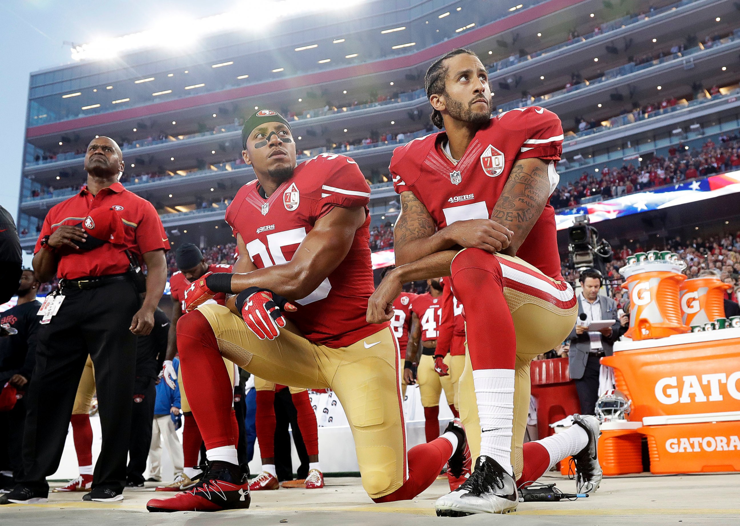 In this Monday, Sept. 12, 2016, file photo, San Francisco 49ers safety Eric Reid (35) and quarterback Colin Kaepernick (7) kneel during the national anthem before an NFL football game against the Los Angeles Rams.