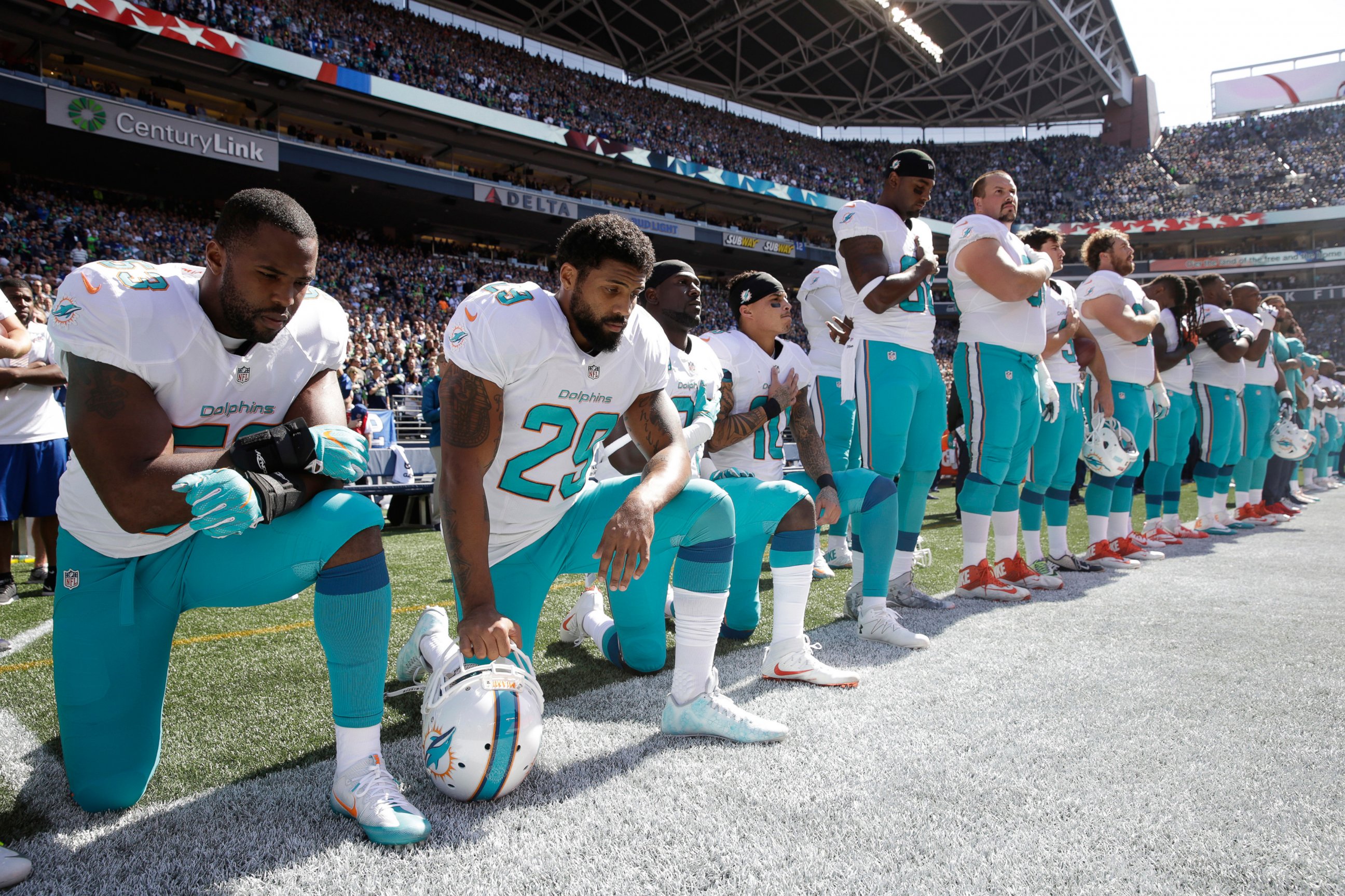 PHOTO: From left, Miami Dolphins' Jelani Jenkins, Arian Foster, Michael Thomas, and Kenny Stills, kneel during the singing of the national anthem before an NFL football game against the Seattle Seahawks, Sept. 11, 2016, in Seattle.