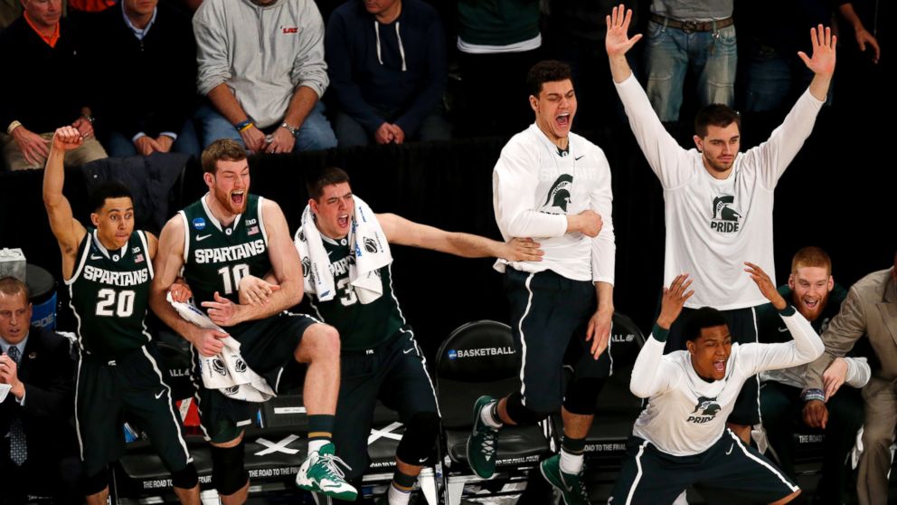 Michigan State players react during second half in a regional semifinal against Virginia at the NCAA men's college basketball tournament, early Saturday, March 29, 2014, in New York. 