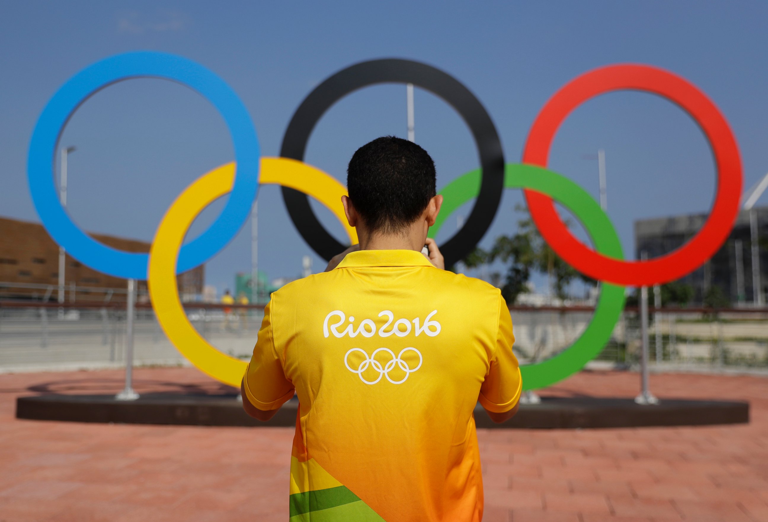 PHOTO: A volunteer photographs a set of Olympic Rings at Olympic Park in Rio de Janeiro, July 29, 2016.