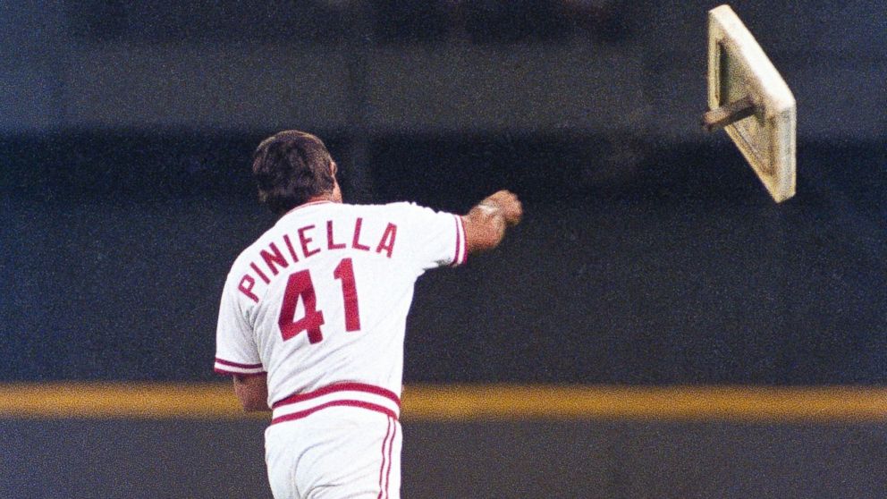 Cincinnati Reds manager Lou Piniella tosses first base into rightfield during their game with the Chicago Cubs at Riverfront Stadium in Cincinnati on April 21, 1990.