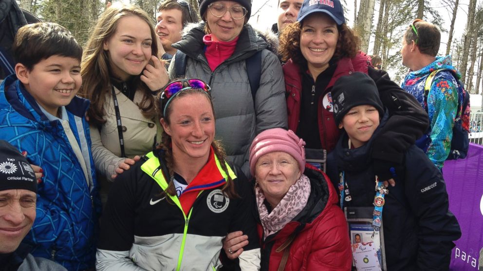 PHOTO: Tatyana Mcfadden poses with her Russian birth mother, second right in the first row, after her race during the ladies 12km cross country ski, sitting event at the 2014 Winter Paralympic, March 9, 2014, in Krasnaya Polyana, Russia.