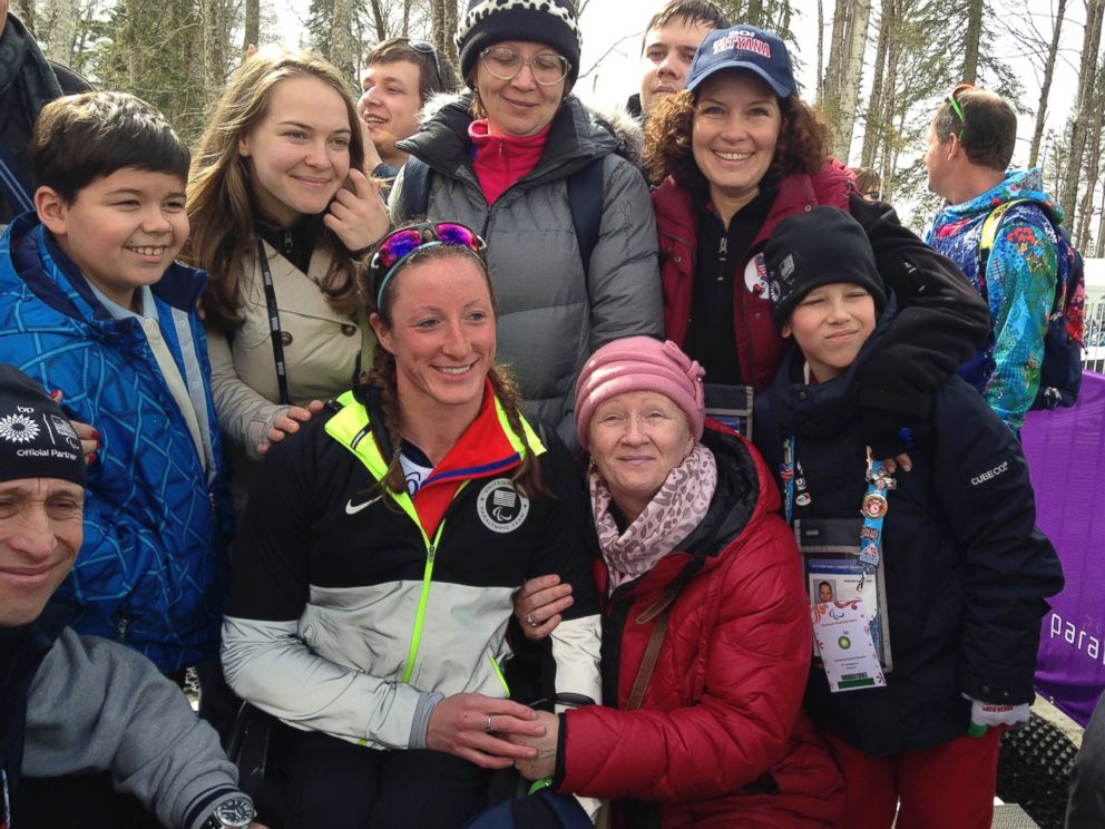 PHOTO: Tatyana Mcfadden poses with her Russian birth mother, second right in the first row, after her race during the ladies 12km cross country ski, sitting event at the 2014 Winter Paralympic, March 9, 2014, in Krasnaya Polyana, Russia.