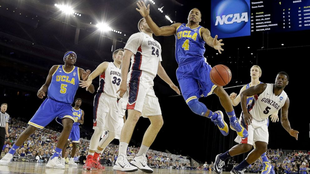 PHOTO: UCLA's Norman Powell (4) loses the ball in front of Gonzaga's Przemek Karnowski (24) during the first half of a college basketball regional semifinal game in the NCAA Tournament, March 27, 2015, in Houston.