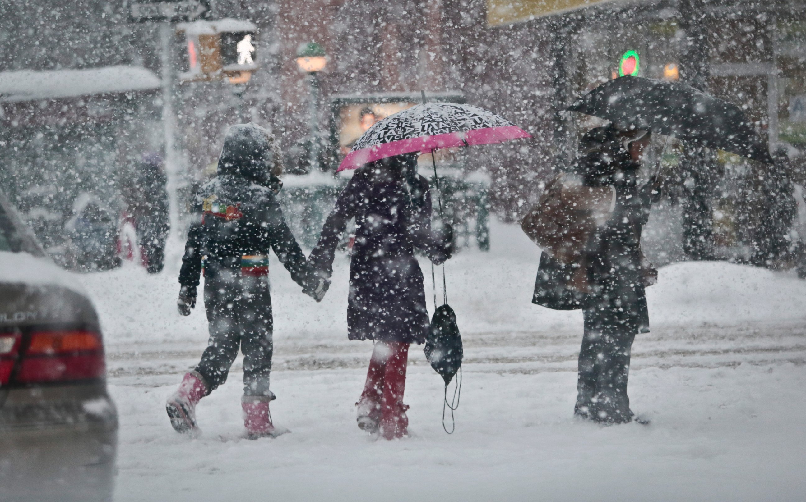 PHOTO: Pedestrians walk along Nostrand Avenue as snowfall blankets the area, Feb. 13, 2014, in the Flatbush section of the Brooklyn borough of N.Y.
