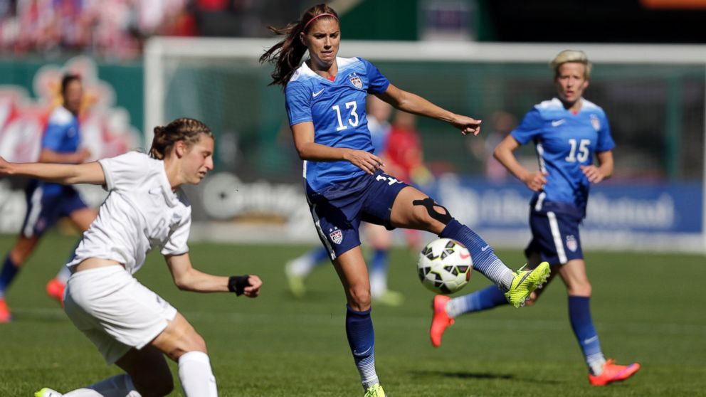 United States player Alex Morgan, center, controls the ball as teammate Megan Rapinoe, right, and New Zealand's Rebekah Stott watch in this April 4, 2015 file photo.