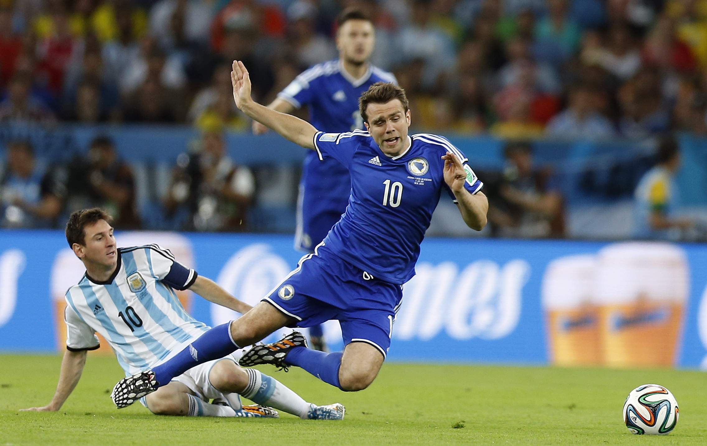 PHOTO: Argentina's Lionel Messi, left, fouls Bosnia's Zvjezdan Misimovic during the group F World Cup soccer match between Argentina and Bosnia at the Maracana Stadium in Rio de Janeiro, Brazil, Sunday, June 15, 2014.  