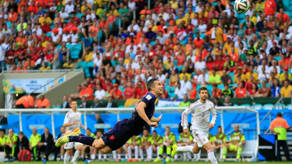 The Netherlands' Robin van Persie attempts the header that scored a goal during the soccer match between Spain and the Netherlands at the Arena Ponte Nova in Salvador, Brazil, June 13, 2014. 