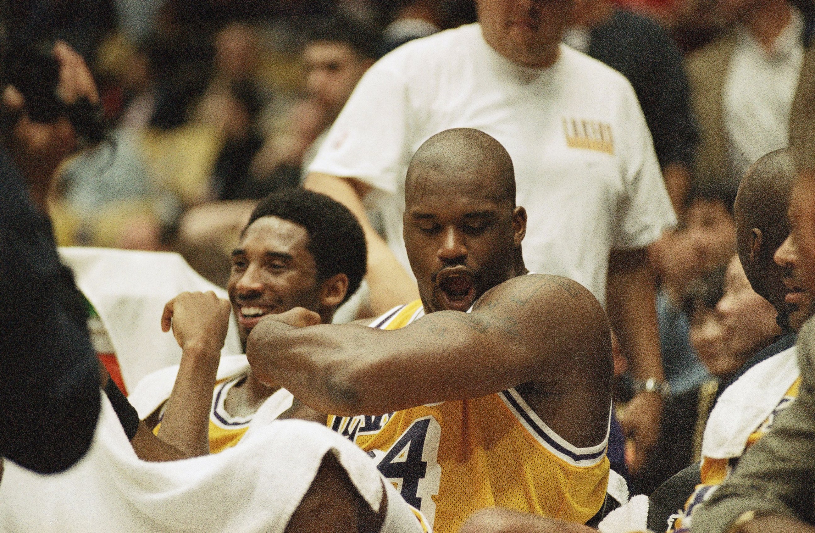 PHOTO: Los Angeles Lakers Shaquille O'Neal, right, flexes his arm as he polishes off his superman tattoo seated next to teammate Kobe Bryant during the fourth quarter of their blowout game against the Chicago Bulls, Feb. 1, 1998, in Inglewood, California.