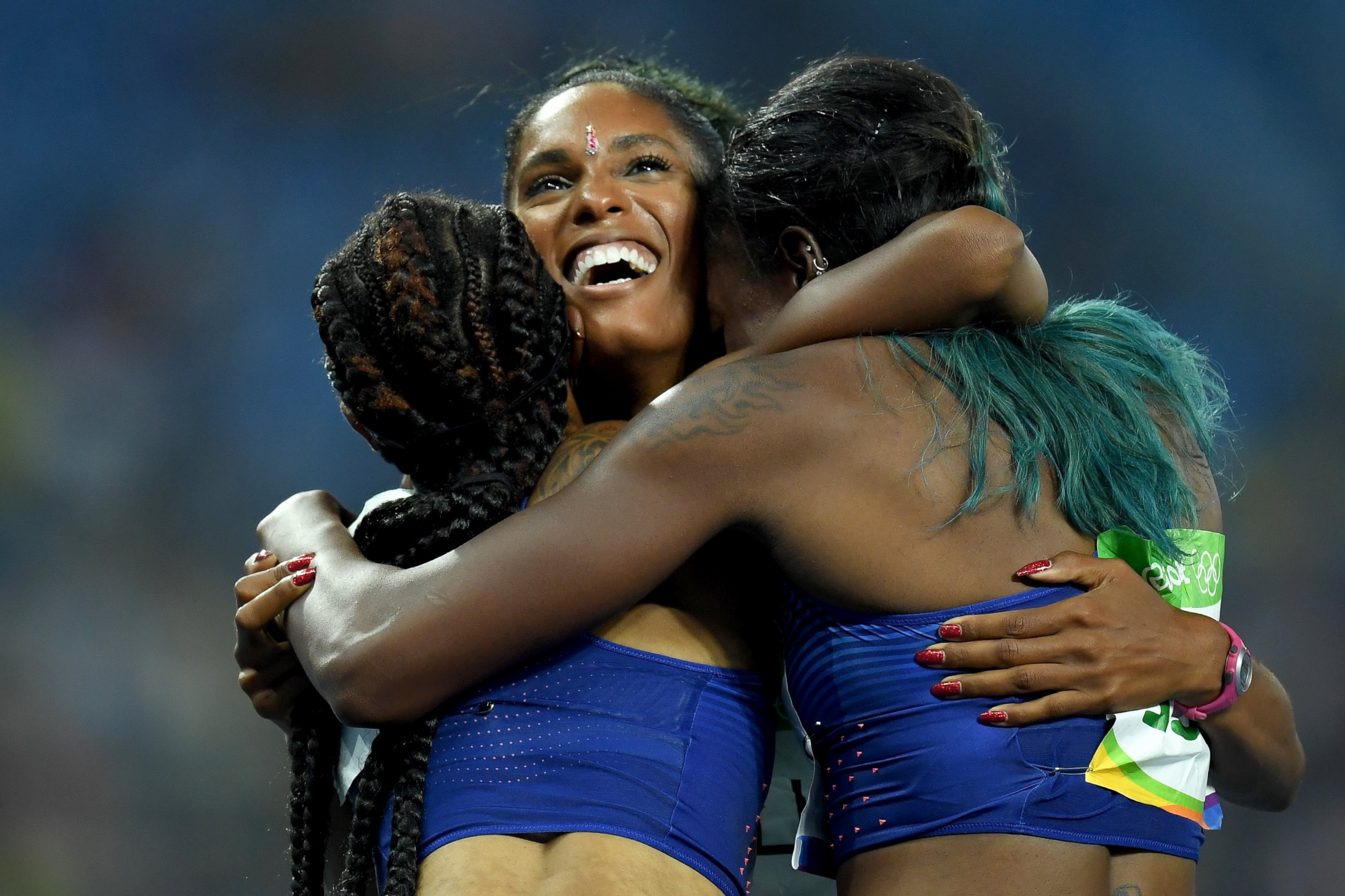 PHOTO: Bronze medalist Kristi Castlin (C) celebrates with gold medalist Brianna Rollins and silver medalist Nia Ali of the United States after the Women's 100m Hurdles Final