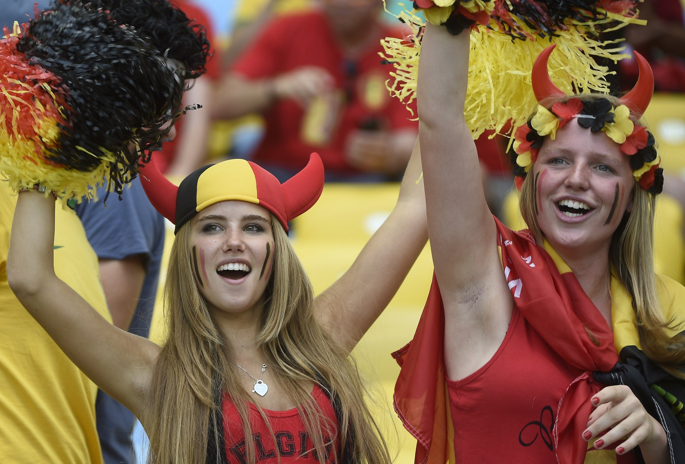 PHOTO: Axelle Despiegelaere, a Belgium supporter cheers with her friend as they wait for the start of the Group H football match between Belgium and Russia at the Maracana Stadium in Rio de Janeiro during the 2014 FIFA World Cup on June 22, 2014.  