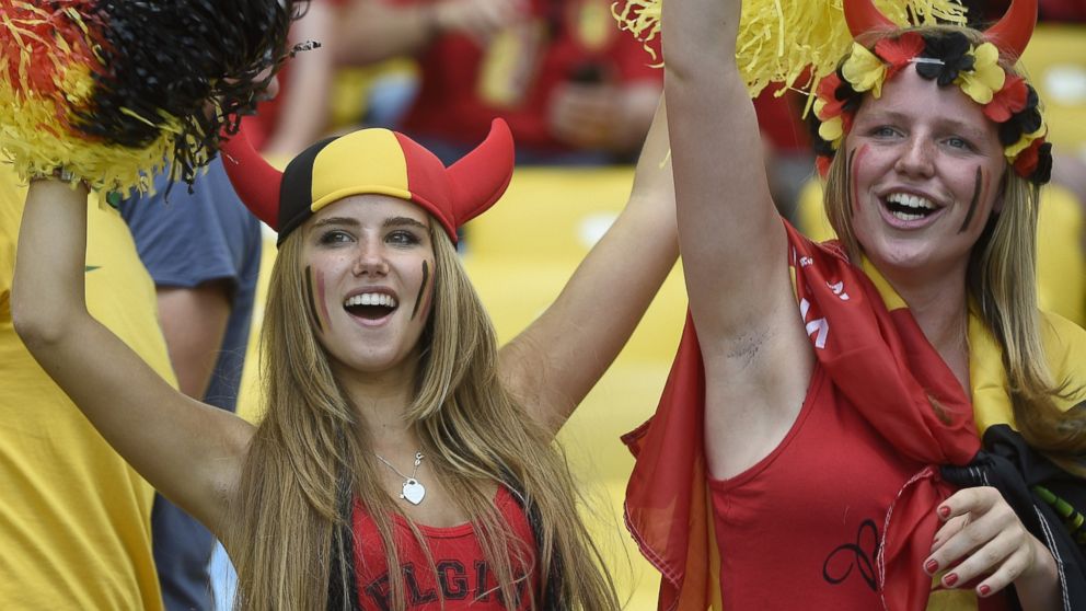 PHOTO: Axelle Despiegelaere, a Belgium supporter cheers with her friend as they wait for the start of the Group H football match between Belgium and Russia at the Maracana Stadium in Rio de Janeiro during the 2014 FIFA World Cup on June 22, 2014.  