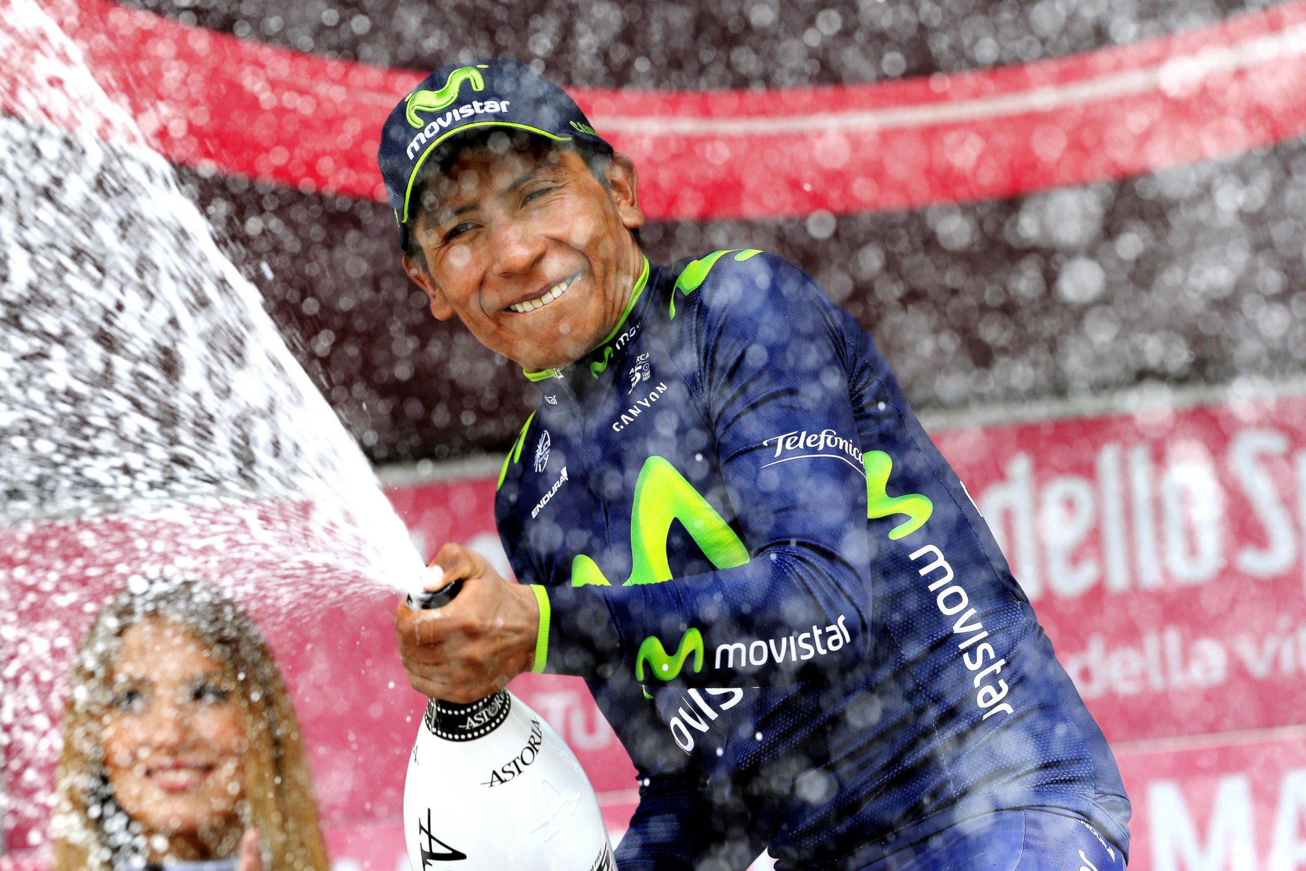 PHOTO: Colombia's Nairo Quintana sprays champagne on the podium as he celebrates winning the 16th stage of the 97th Giro d'Italia (Tour of Italy) cycling race, 139 km from Ponte di Legno to Val Martello, on May 27, 2014 in Val Martello.