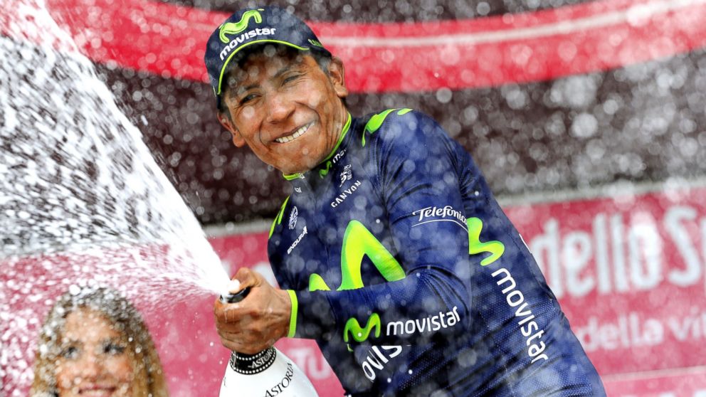 PHOTO: Colombia's Nairo Quintana sprays champagne on the podium as he celebrates winning the 16th stage of the 97th Giro d'Italia (Tour of Italy) cycling race, 139 km from Ponte di Legno to Val Martello, on May 27, 2014 in Val Martello.