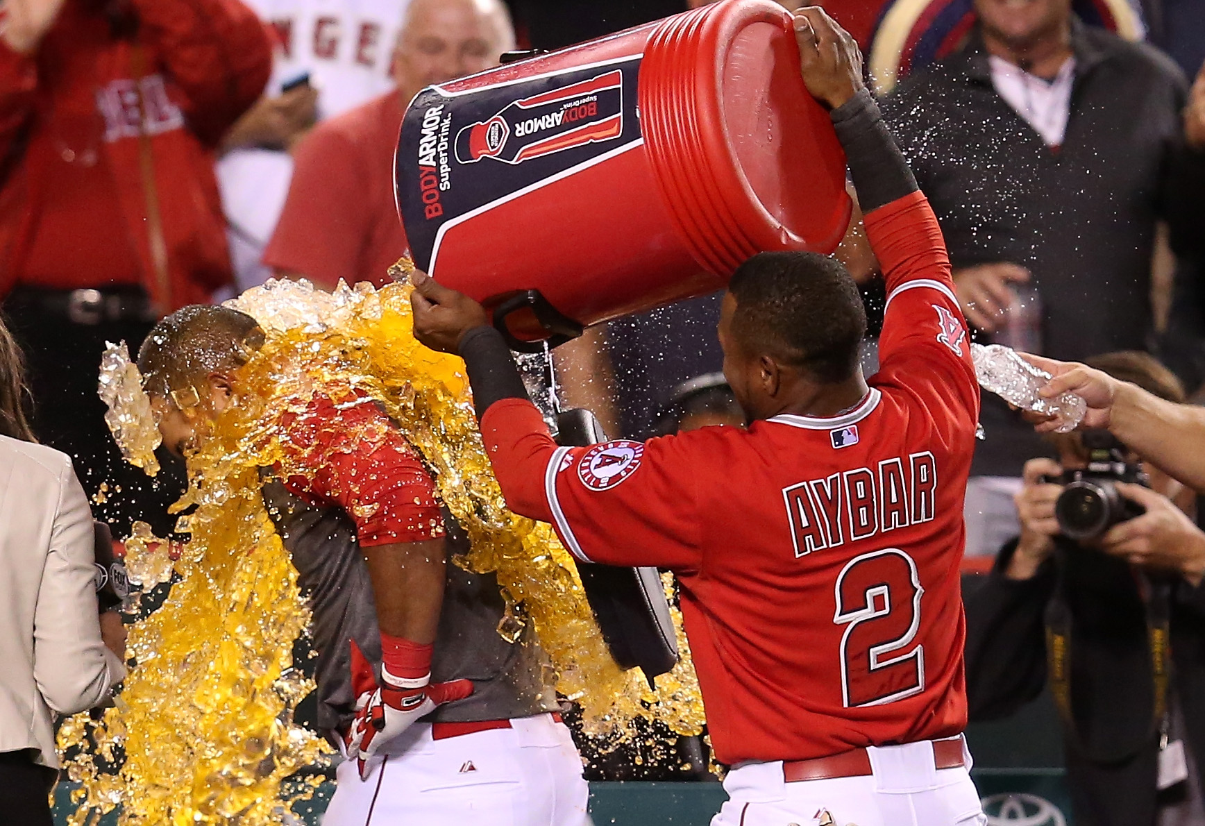 PHOTO: Carlos Perez is doused with sports drink by Erck Aybar after Perez led off the ninth inning with a walk-off home run, May 5, 2015 in Anaheim, California.