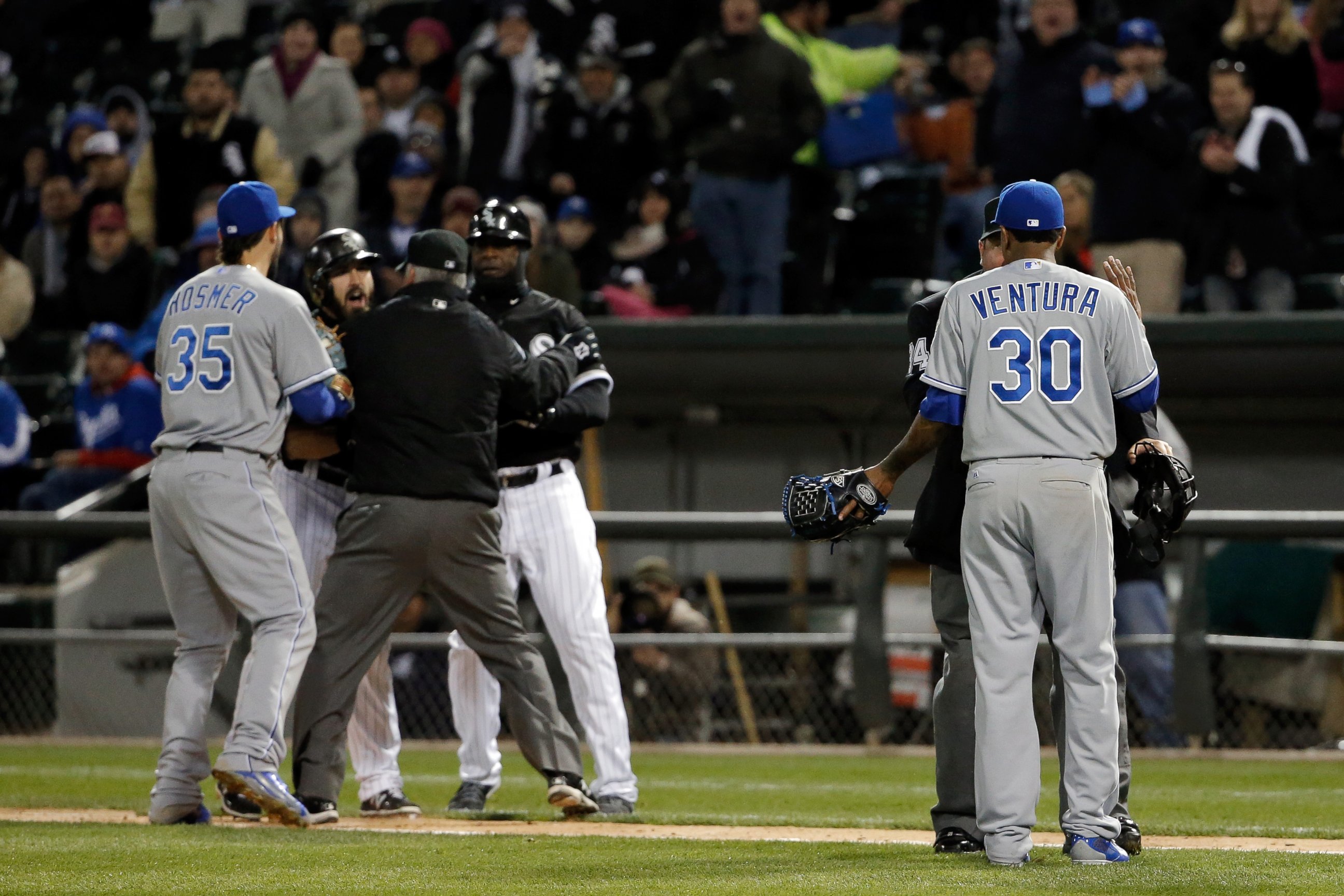 PHOTO: Yordano Ventura of the Kansas City Royals talks to umpire Sam Holbrook Adam Eaton of the Chicago White Sox is restrained during the seventh inning on April 23, 2015 at U.S. Cellular Field in Chicago, Illinois.