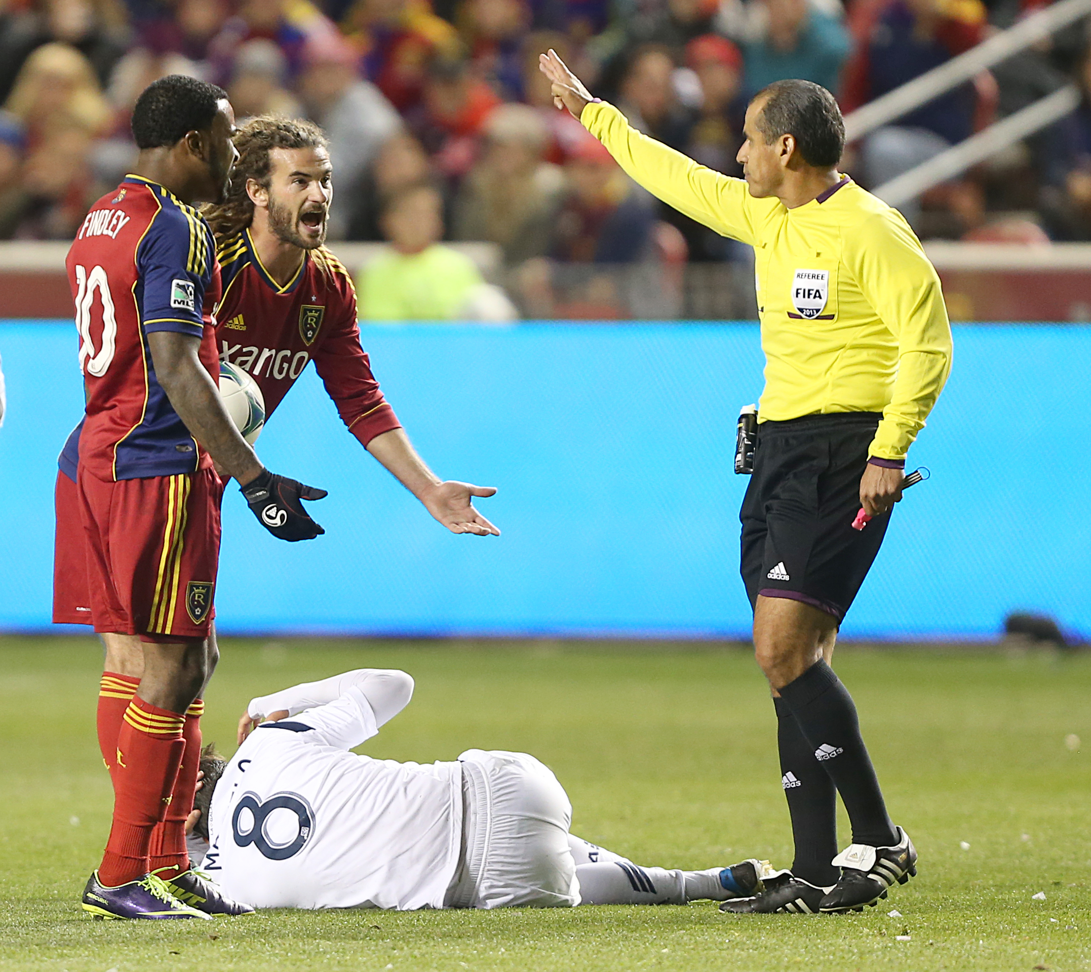 PHOTO: Robbie Findley and Kyle Beckerman of Real Salt Lake argues with an official as Marcelo Sarvas of the Los Angeles Galaxy lies on the ground.