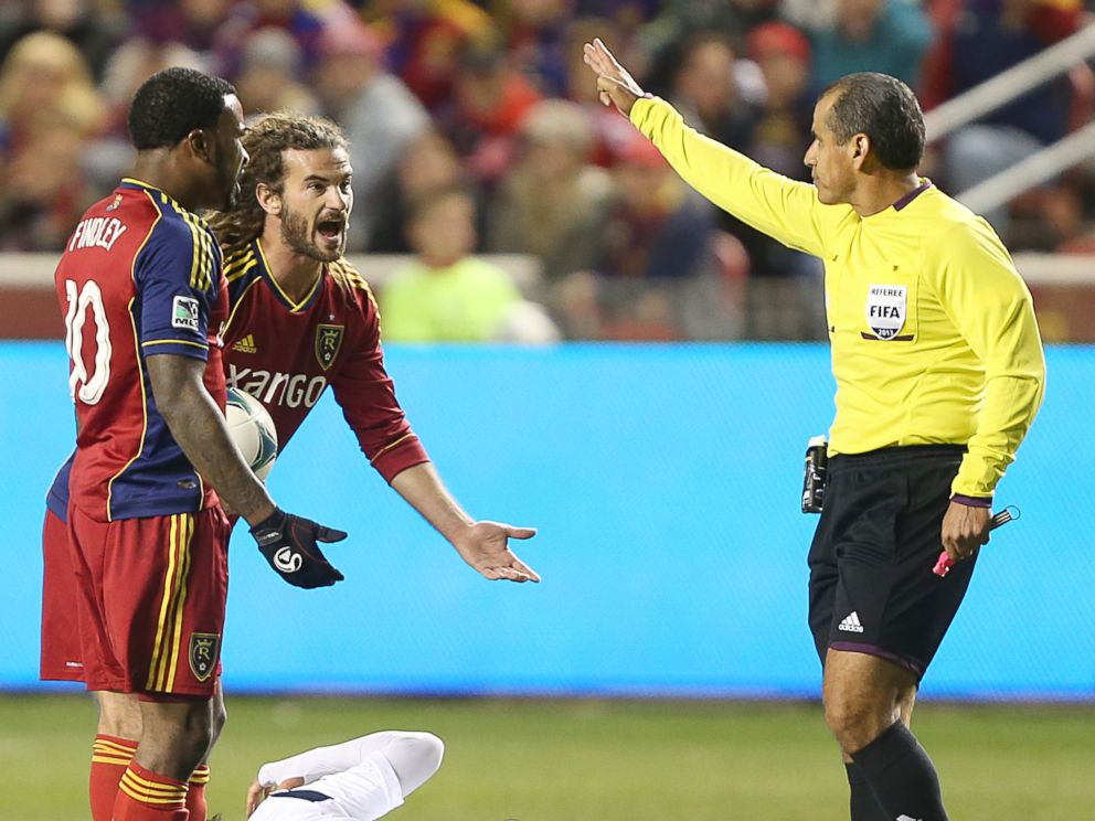PHOTO: Robbie Findley and Kyle Beckerman of Real Salt Lake argues with an official as Marcelo Sarvas of the Los Angeles Galaxy lies on the ground.