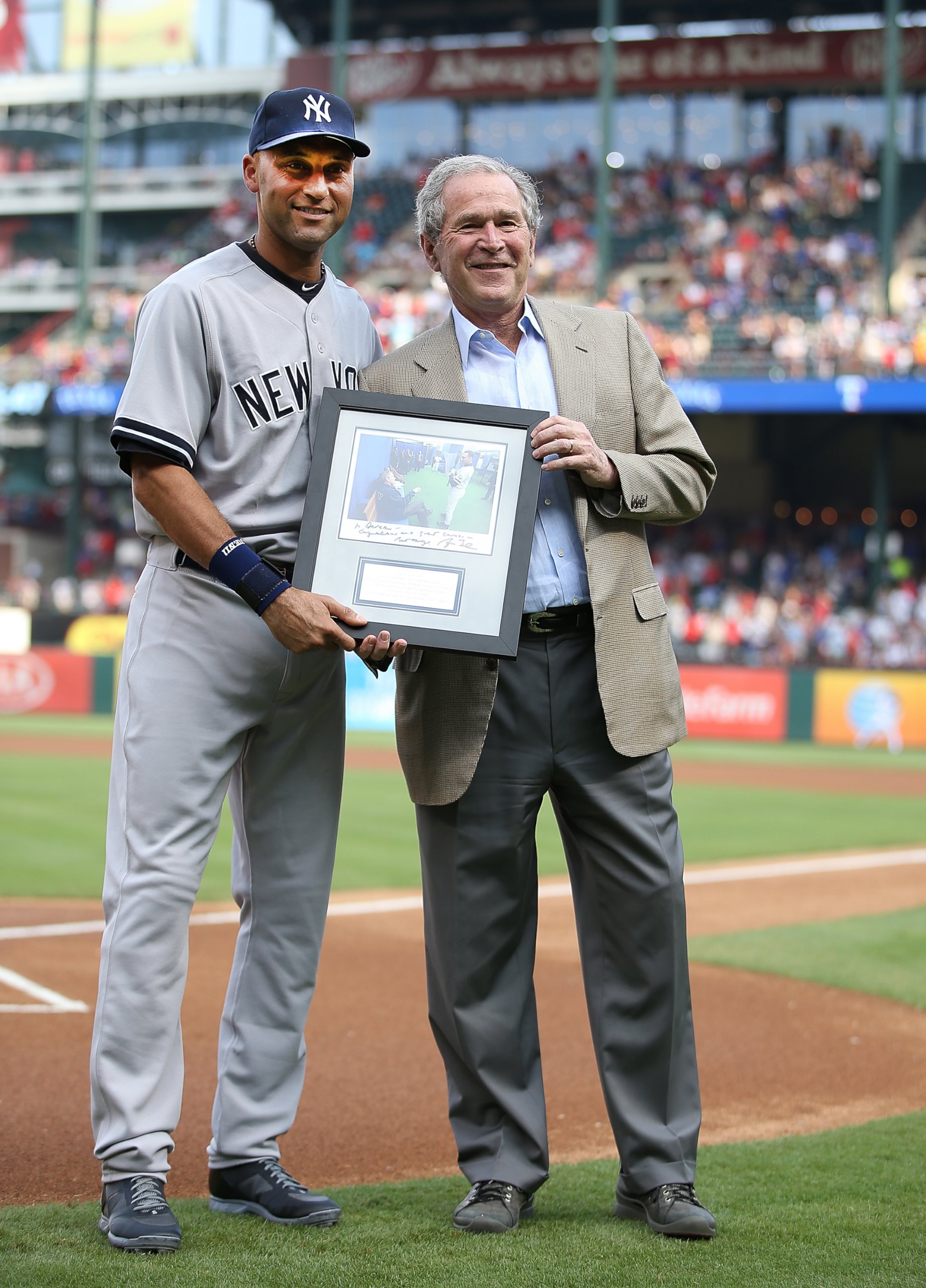 PHOTO: Derek Jeter is presented with a photo by President George W. Bush during a ceremony