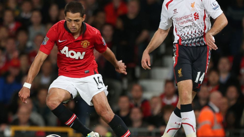 Javier "Chicharito" Hernandez of Manchester United in action with Jordan Henderson of Liverpool during the Capital One Cup Third Round match between Manchester United and Liverpool at Old Trafford in this Sept. 25, 2013, file photo in Manchester, England.   