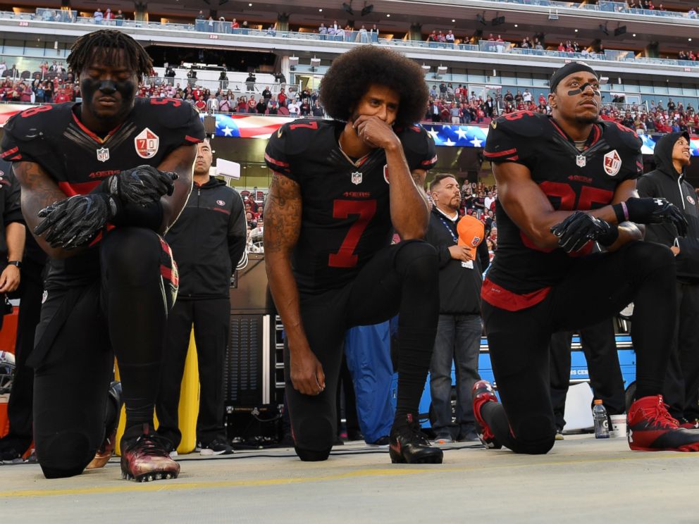 PHOTO: From left, Eli Harold, #58, Colin Kaepernick, #7, and Eric Reid, #35, of the San Francisco 49ers kneel in protest during the national anthem prior to their NFL game against the Arizona Cardinals, Oct. 6, 2016, in Santa Clara, California.