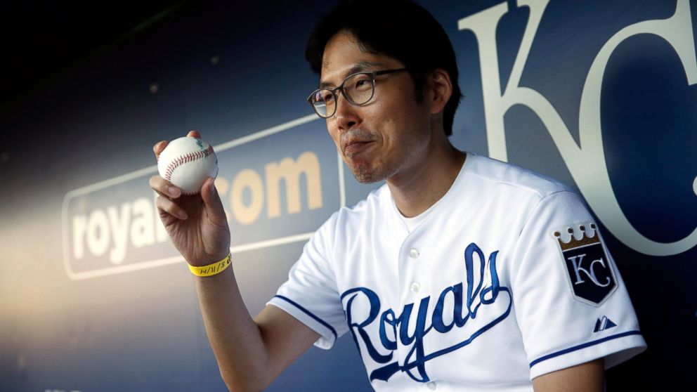 PHOTO: Kansas City Royals fan Sungwoo Lee of Korea shows of a signed baseball prior to the game against the Oakland Athletics at Kauffman Stadium, Aug. 11, 2014, in Kansas City, Mo. 
