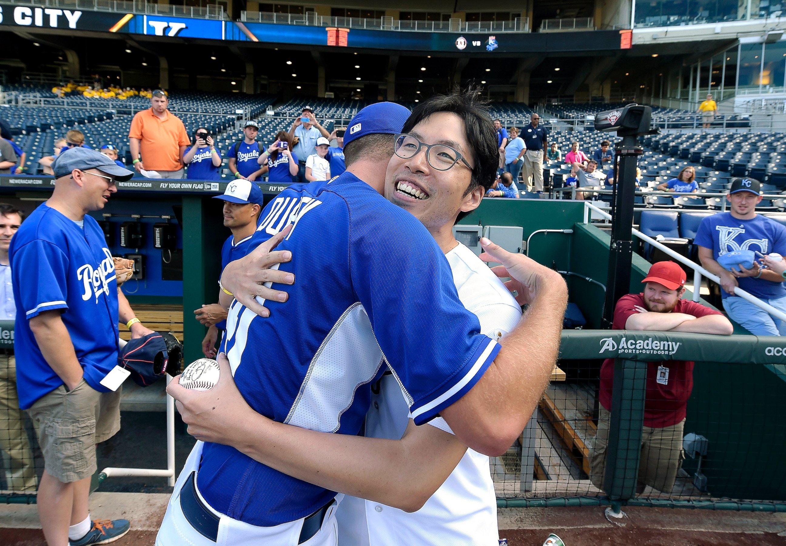 PHOTO: Kansas City Royals fan Sungwoo Lee, from South Korea, hugs Royals pitcher Danny Duffy after meeting before the team's game against the Oakland Athletics, Aug. 11, 2014, at Kauffman Stadium in Kansas City, Mo.