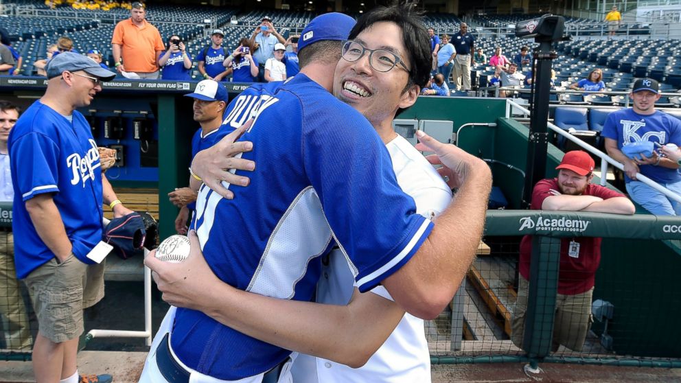 PHOTO: Kansas City Royals fan Sungwoo Lee, from South Korea, hugs Royals pitcher Danny Duffy after meeting before the team's game against the Oakland Athletics, Aug. 11, 2014, at Kauffman Stadium in Kansas City, Mo.
