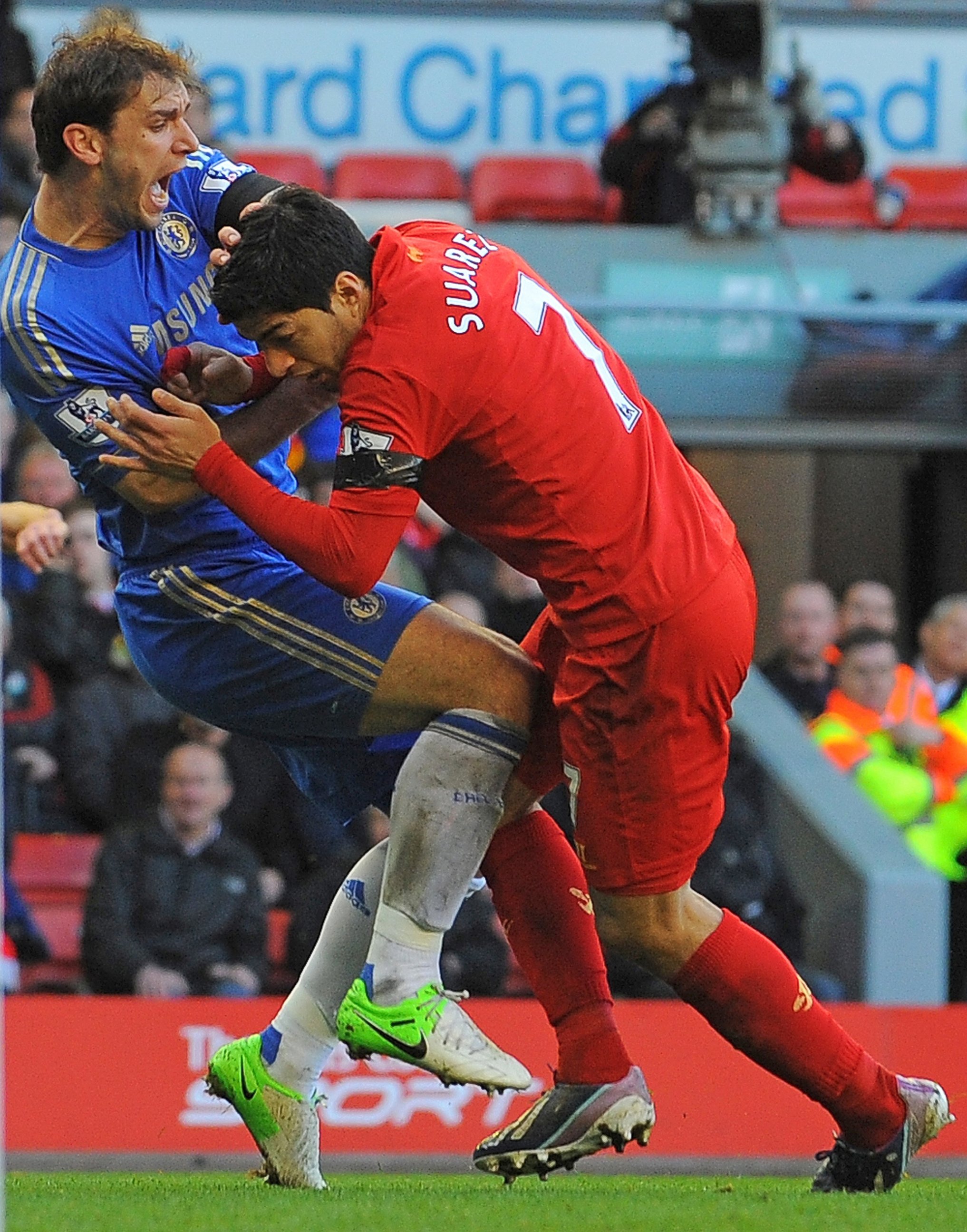 PHOTO: Liverpool's Uruguayan striker Luis Suarez, right, clashes with Chelsea's Serbian defender Branislav Ivanovic after appearing to bite the Chelsea player during the English Premier League football match. 