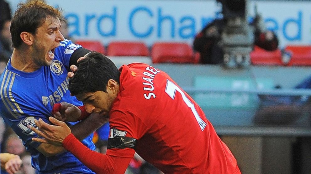 PHOTO: Liverpool's Uruguayan striker Luis Suarez, right, clashes with Chelsea's Serbian defender Branislav Ivanovic after appearing to bite the Chelsea player during the English Premier League football match. 