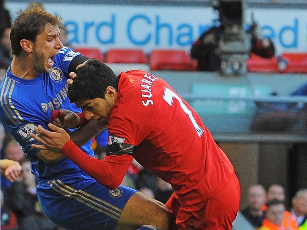 PHOTO: Liverpools Uruguayan striker Luis Suarez, right, clashes with Chelseas Serbian defender Branislav Ivanovic after appearing to bite the Chelsea player during the English Premier League football match.