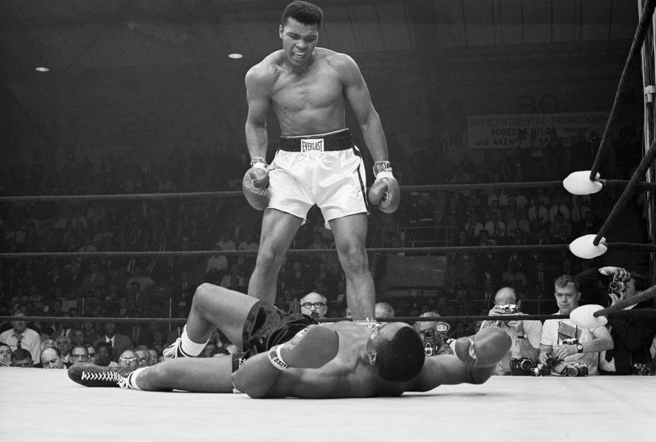PHOTO: Heavyweight champion Muhammad Ali stands over Sonny Liston and taunts him to get up during their title fight. 
