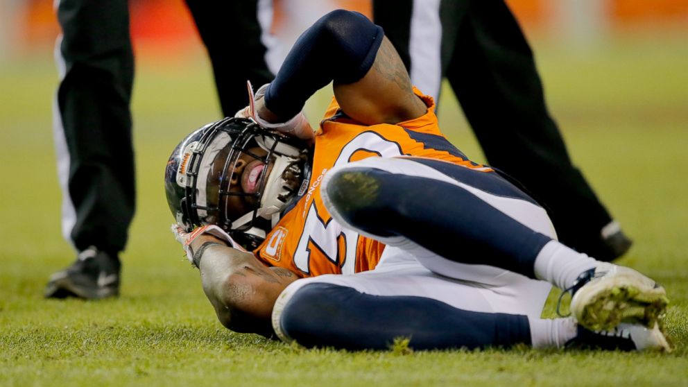 PHOTO: David Bruton #30 of the Denver Broncos lies on the ground in pain after a play that would force him out of the game with a reported concussion, Dec. 28, 2014, in Denver.