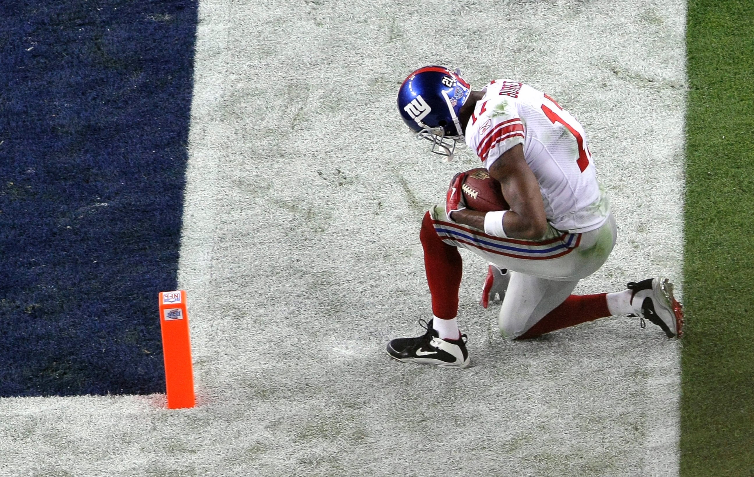 PHOTO: Plaxico Burress #17 of the New York Giants kneels just outside the end zone after he scored on a touchdown reception against the New England Patriots during Super Bowl XLII, Feb. 3, 2008, at the University of Phoenix Stadium in Glendale, Ariz.