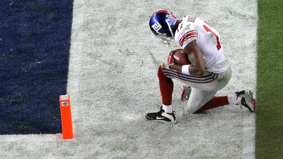 PHOTO: Plaxico Burress #17 of the New York Giants kneels just outside the end zone after he scored on a touchdown reception against the New England Patriots during Super Bowl XLII, Feb. 3, 2008, at the University of Phoenix Stadium in Glendale, Ariz.