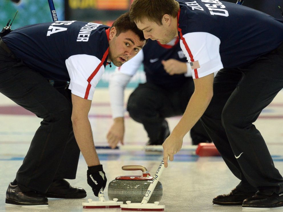 PHOTO: Jared Zezel and John Landsteiner of the US clean the way for the stone
