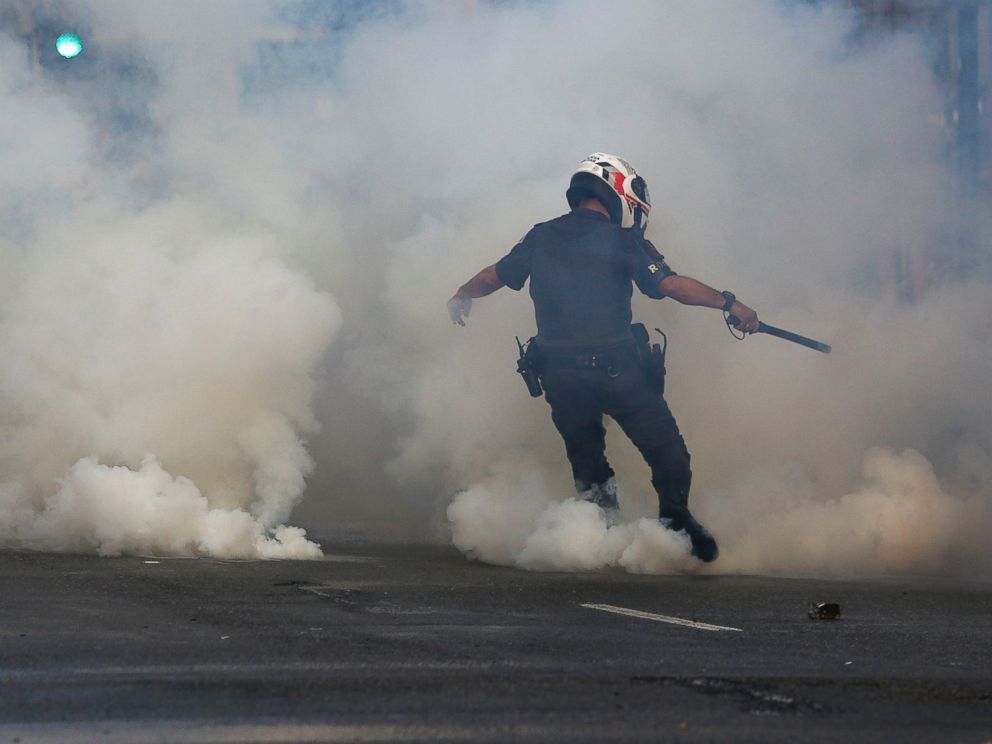 PHOTO: A policeman kicks a tear gas canister as supporters of Brazilian suspended President Dilma Rousseff protest against interim president Michel Temer, in Sao Paulo, Brazil, June 1, 2016.
