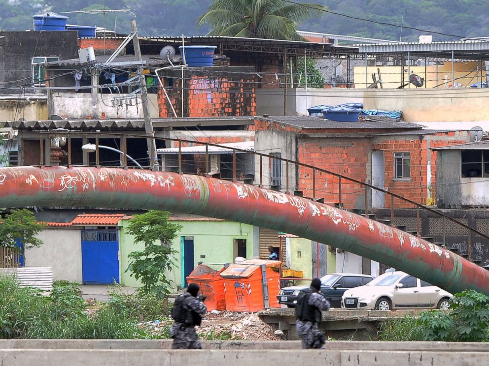 PHOTO: PM paramilitary police personnel man a checkpoint on a bridge in the Cidade de Deus shantytown, 10km from the Olympic Village Rio de Janeiro, Brazil, July 21, 2016.