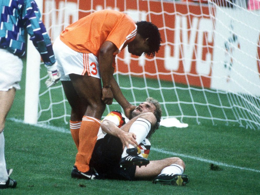 PHOTO: West Germanys Rudi Voeller, right, clashes with Hollands Frank Rijkaard, center, as Dutch goalkeeper Hans Van Breukelen, left, watches on June 24, 1990 in Milan, Italy. Rijkaard later spat on Voeller as they left the field after being sent off.