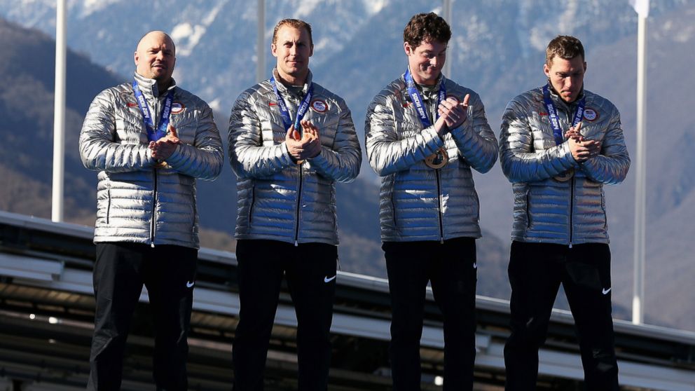 Bronze medalists the United States team 1 celebrate on the podium during the medal ceremony for the four-man bobsleigh on Feb. 23, 2014 during the Sochi 2014 Winter Olympics in Sochi, Russia.  