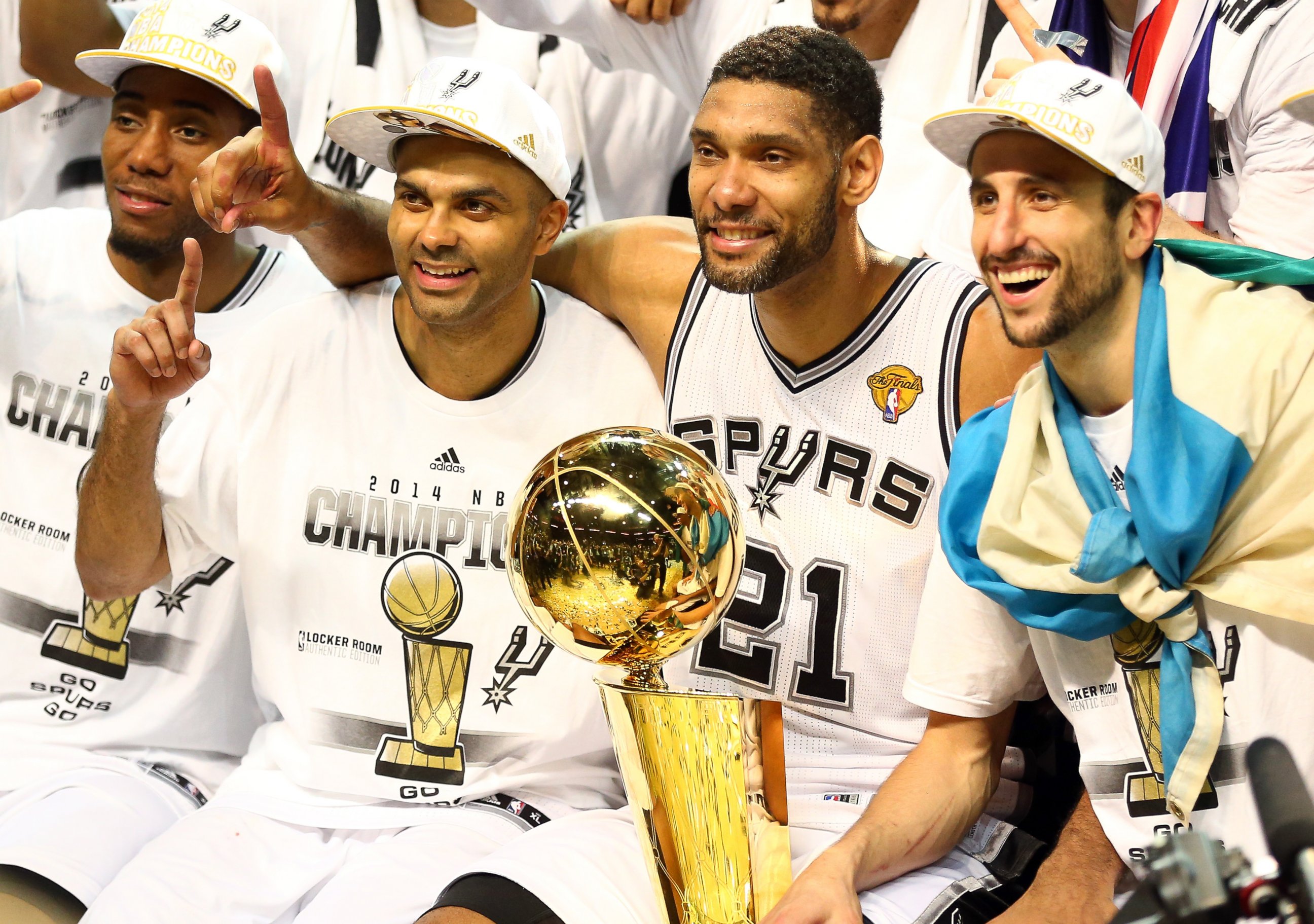 The San Antonio Spurs celebrate with the Larry O'Brien trophy