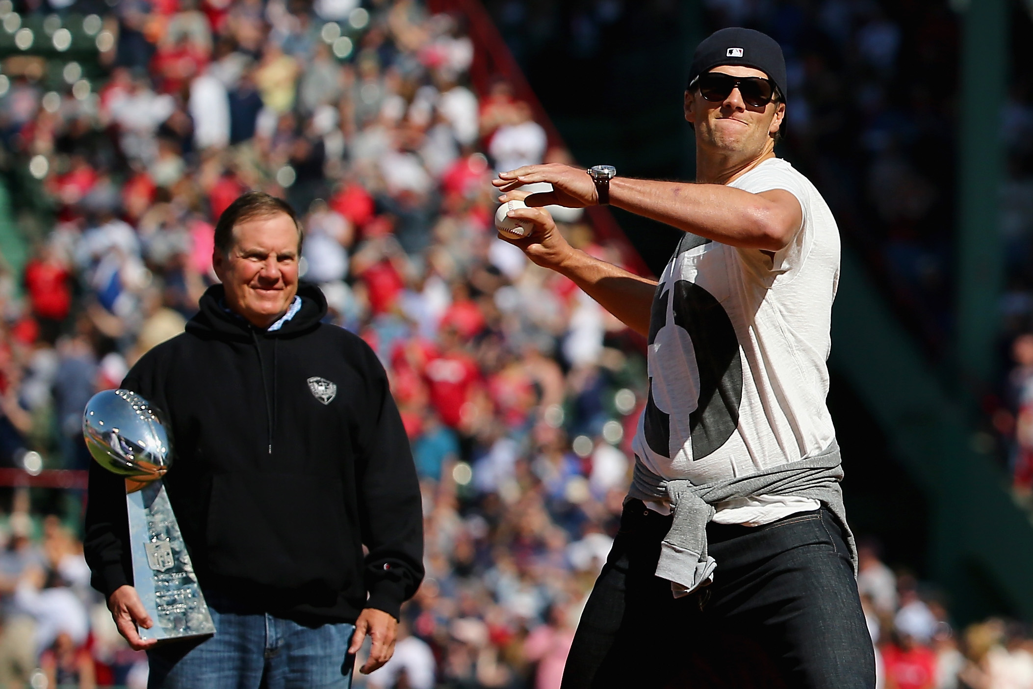 PHOTO: Patriots quarterback Tom Brady, right, threw out the ceremonial first pitch at the Boston Red Sox home opener, as Bill Belichick, left, looks on in Boston on April 13, 2015. 
