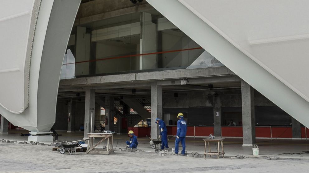 PHOTO: Workers prepare the surroundings of the Arena da Amazonia Vivaldo Lima in Manaus, Brazil, on April 9, 2014. 