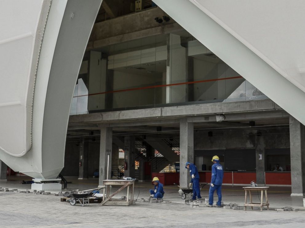 PHOTO: Workers prepare the surroundings of the Arena da Amazonia Vivaldo Lima in Manaus, Brazil, on April 9, 2014.