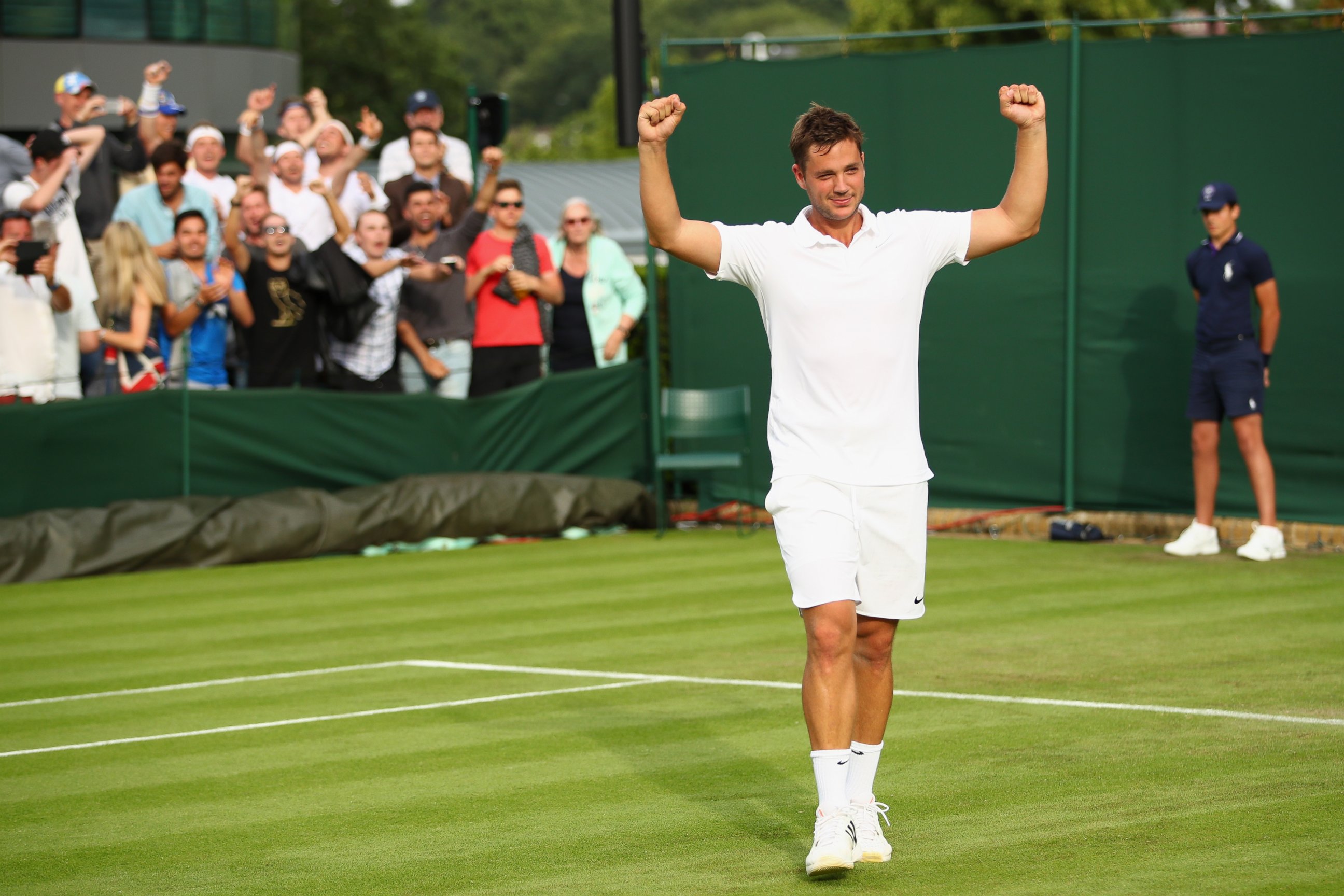 PHOTO: Marcus Willis celebrates upset victory during the Men's Singles first round match against Ricardas Berankis at Wimbledon on June 27, 2016 in London.