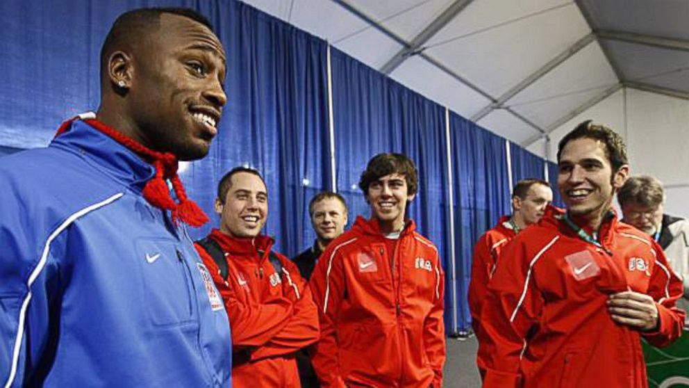 Professional football player Vernon Davis, left, is joined by Team USA Curling at the 2010 Olympic Winter Games in Vancouver, British Columbia, Canada.